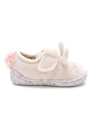 Chaussure de bébé beige douce avec des oreilles de lapin, une queue pompon rose et une semelle à motif floral, sécurisée par une bride velcro.