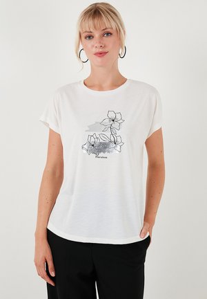 Hvid bomulds t-shirt med sort blomsterkonturprint og teksten "Floraison." Korte ærmer og rund halsudskæring, afslappet pasform.
