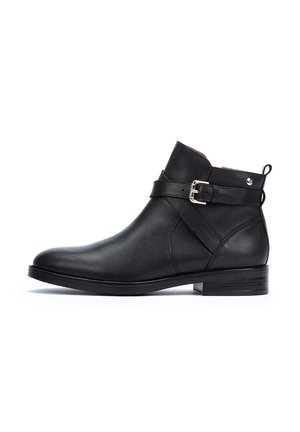 Bottines en cuir noir avec une sangle latérale et une boucle en argent, bout arrondi et un petit talon empilé. Texture lisse avec un minimalisme dans les détails.