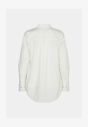 Camicia bianca a maniche lunghe con cucitura sulla spalla posteriore, orlo arrotondato e polsini con bottone. Il tessuto appare liscio con una texture morbida e leggera.