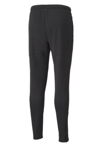 Svarta träningsbyxor med en slät yta, elastisk midja och smalnande ben. Har detaljer vid sidsömmen och dragkedjor vid anklarna för justerbar passform.