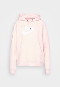 Ljust rosa Nike-huvtröja med en känguruficka, snörning i huvan och vit logotyp över bröstet; mjukt tyg och ribbade ärmslut.