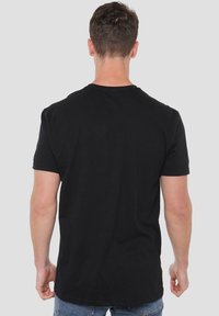 Black cotton short-sleeve t-shirt with a classic crew neck design, featuring a smooth texture and no visible patterns or accents.