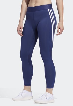 Marineblå trænings leggings med en bred talje, der har hvide tre-stripes accenter på siden og strukturerede paneler for åndbarhed.