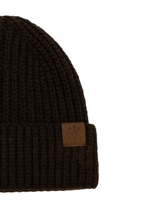 Knitted dark brown beanie with a folded cuff. Features a square leather patch with a snowflake design on the front.