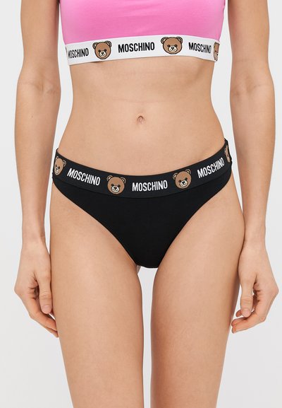 Črne hlačke z pasom z logotipom medveda in belim napisom. Mehka tkanina, minimalističen dizajn, nizko rezanje.