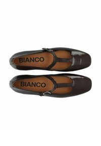 Zapatos planos de charol marrón con tira T, punta cuadrada, acento de hebilla plateada y plantilla beige con el nombre de la marca "BIANCO."