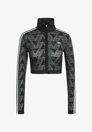 Zwarte cropped ritsjack met hoge kraag, voorzien van een getextureerd chevronpatroon en witte zijstrepen. Gemaakt van lichtgewicht, ademende stof.