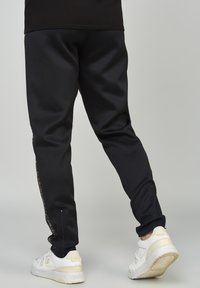SIKSILK Tracksuit bottoms - black