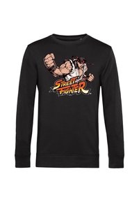 Felpa nera a maniche lunghe con una grafica di un personaggio muscoloso in azione e testo "Street Fighter" in colori vivaci. Tessuto morbido.