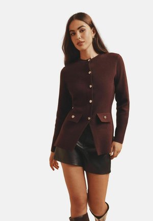 Burgundy cardigan with long sleeves, front buttons, and two flap pockets. Smooth texture, tailored design, and fitted silhouette.
