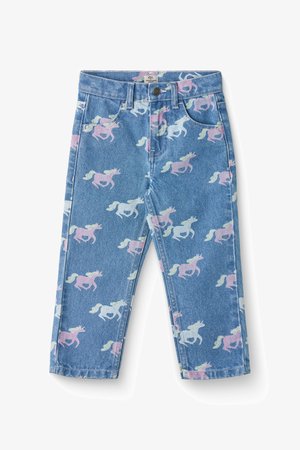 Svijetloplave traperice s ponovljenim uzorkom ružičastih i bijelih jednoroga. Klasičan dizajn s pet džepova, zatvaranje na patentni zatvarač i dugme.