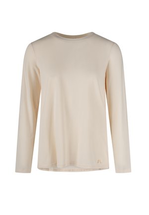 Cream-colored long-sleeve crew neck shirt with a small decorative bow near the bottom hem on a plain white background.