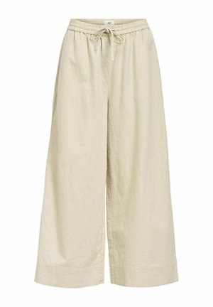 Beige, brede benbukser lavet af letvægtsstof, med en elastisk taljehøjden og snoretræk, samt sidelommer. Teksturering.