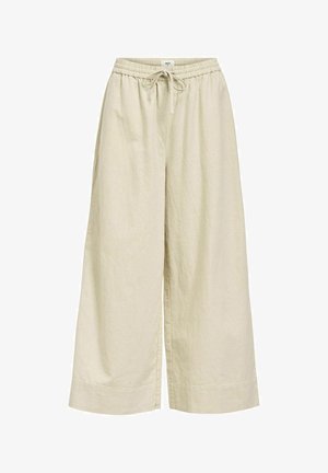 Pantaloni beige a gamba larga realizzati in tessuto leggero, con un elastico in vita e cordoncino, e tasche laterali. Finitura texturizzata.