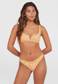 Orange and pink patterned bikini set featuring a molded cup top with wide straps and low-rise brief with minimal coverage, textured fabric.