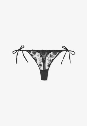 Black lace thong with floral embroidery, featuring sheer panels and adjustable ties on both sides. Soft fabric with a smooth texture.