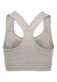 Brassière de sport beige sans couture avec larges bretelles croisées dans le dos et tissu texturé sur la bande inférieure pour un soutien et un confort optimaux.