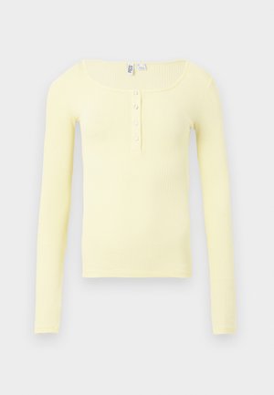 Yellow ribbed long-sleeve top with a scoop neck and five-button placket at the chest. Smooth texture and fitted design.