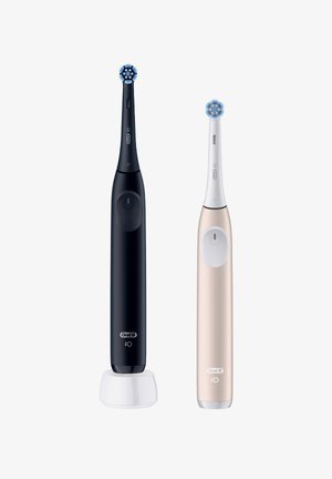 Two electric toothbrushes: one black with a circular brush head and a white accent, and one rose gold with a similar design, both sleek.