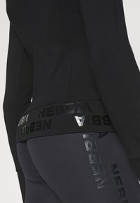 Nebbia NEBBIA WOMEN'S ZIP-UP JACKET INTENSE WARM-UP - Treningsjakke - black