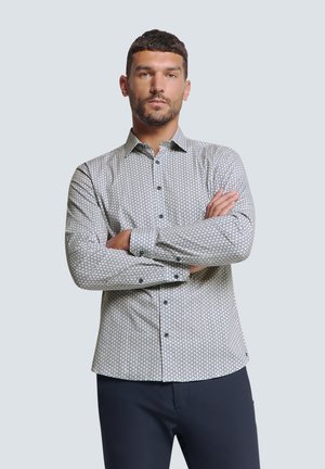 Witte overhemd met lange mouwen, voorzien van een geometrisch patroon in navy en groen, met een button-down kraag en contrasterende zwarte knopen. Gestructureerde stof.