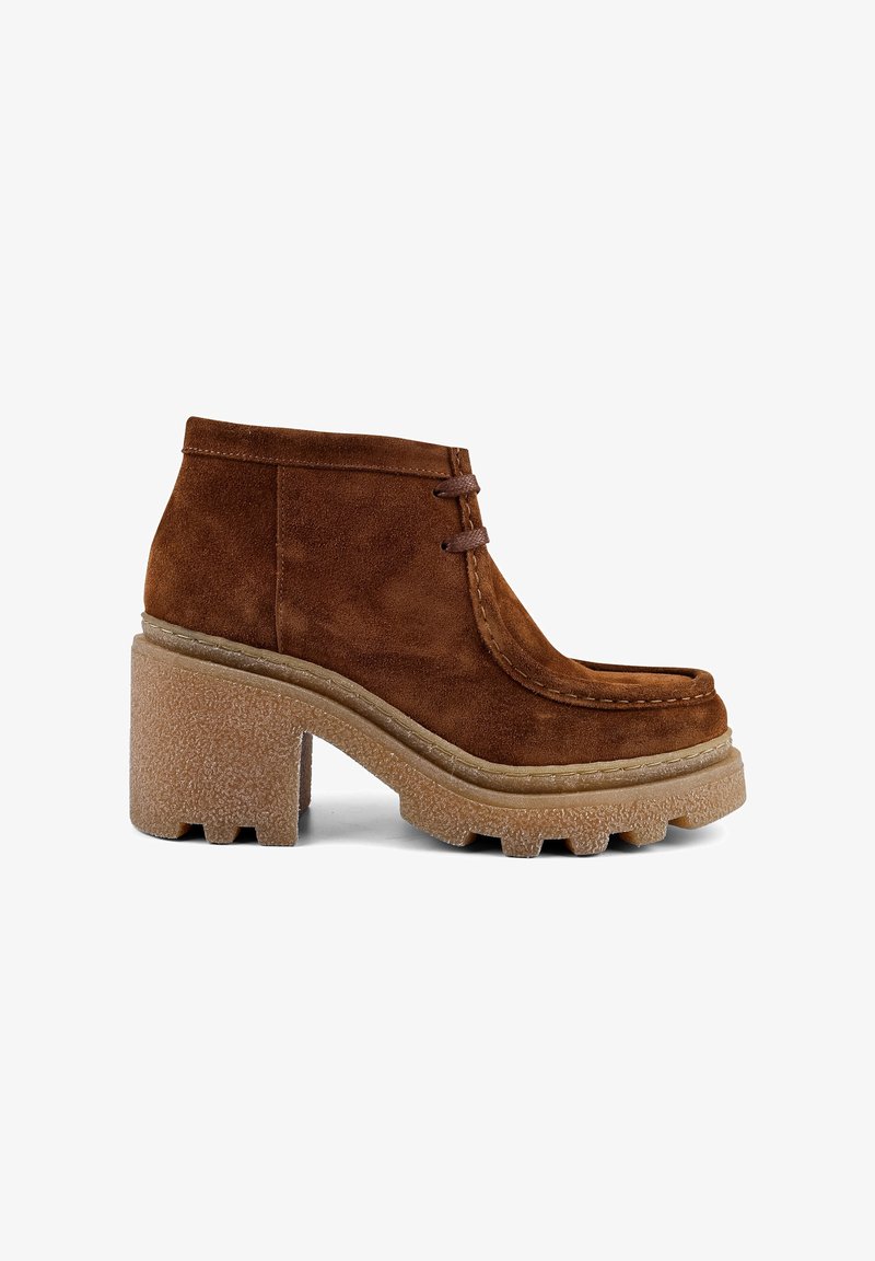 Brown suede ankle boots featuring a rounded toe, two decorative laces, and a chunky textured sole with a raised tread.