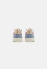 Suede sneakers featuring pink, blue, and beige sections; soft texture, rounded shape, and white rubber sole. Geox logo on the heel.