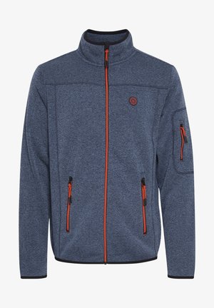 Fleecejakke i mørkeblå med et strukturert mønster. Har oransje glidelåser, høy krage og flere glidelåslommer på forsiden og ermene.