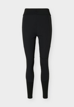 Leggings negros ajustados de talle alto con detalles en paneles en las rodillas y partes bajas de las piernas, adecuados para deportes o uso casual.