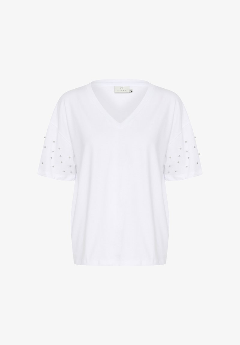 Maglietta bianca a V con maniche corte, caratterizzata da borchie trasparenti decorative sulle maniche. Realizzata in morbido tessuto, con vestibilità rilassata e design minimal.