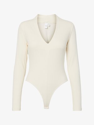 Ribbed long-sleeve bodysuit in cream, featuring a deep V-neck, fitted shape, and thong bottom for a streamlined silhouette.