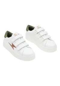 Baskets en cuir blanc avec trois bandes Velcro réglables, accents verts sur le col et une semelle en caoutchouc texturée arborant un design en forme d'éclair.