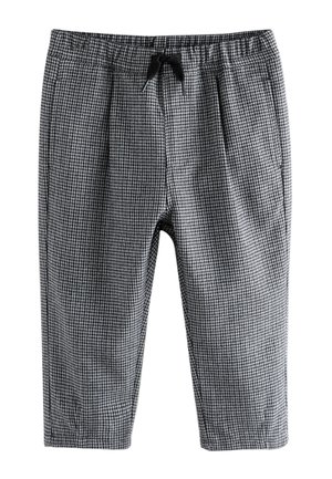 Pantalon à motif pied-de-poule noir et blanc avec taille élastique et cordon noir, longueur courte et coupe ajustée.