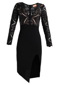 Černé šaty s krajkovým tělem, dlouhými rukávy, přiléhavým střihem a rozparkem až ke stehnům. Jednoduchý a elegantní design.