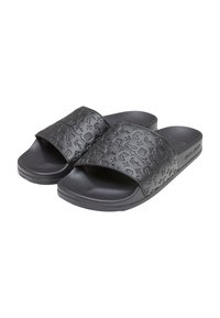 Black slide sandals with an embossed pattern on the upper band, featuring a flat sole for comfort and a minimalist design.
