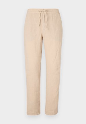 Beige linnebyxor med dragsko i midjan, raka ben och en mjuk, strukturerad yta. Har två sidfickor och minimal sömnadsdetalj.