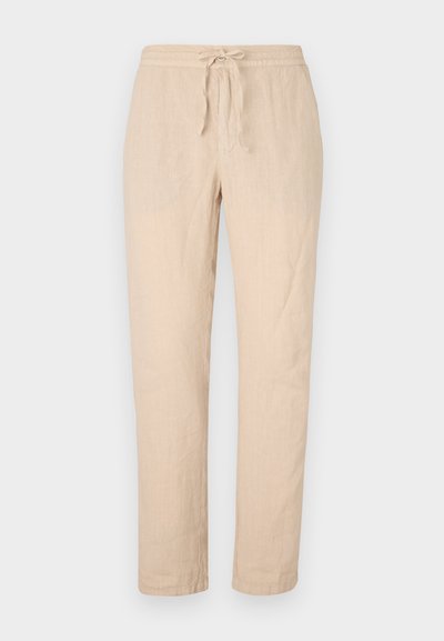 Beige linen pants with a drawstring waist, straight legs, and a soft, textured finish. Features two side pockets and minimal stitching detail.
