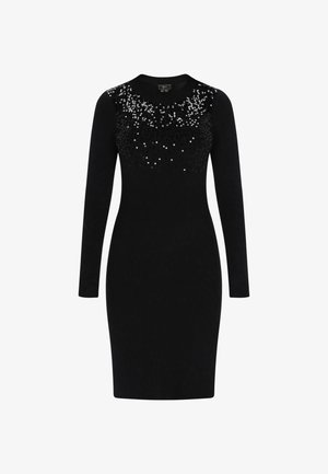 Zwart lang mouw aansluitend jurk met ronde halslijn, versierd met zilveren pailletten die naar beneden vervagen op de borst en schouders.