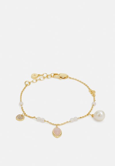 Gold chain bracelet featuring a large pearl, rose quartz pendant, and small crystal charm, with smooth beads interspersed along the chain.