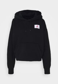 Zwarte cropped hoodie gemaakt van een katoenmix. Voorzien van een kangaroezak aan de voorkant en een witte patch met een rood logo op de linkerborst.