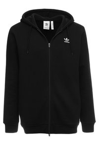 Svart Adidas zip-up hoodie med huva, framfickor, snoddar och liten vit Adidas trefoil-logga på vänster bröst.