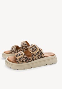 Leopard print slide sandals with two wide straps, gold-tone buckles, and a light beige sole. Textured upper and smooth footbed.