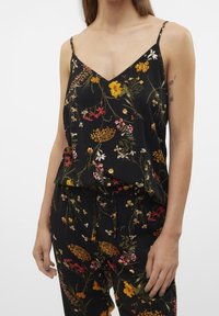 Canotta nera a fiori con spalline sottili, caratterizzata da un motivo floreale multicolore, tessuto morbido e una vestibilità rilassata progettata per il comfort.
