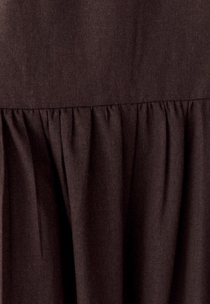 Brown fabric with a textured, woven appearance. Features a gathered design at the hem, creating a soft, flowing silhouette.