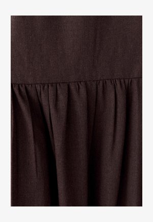 Brown fabric with a textured, woven appearance. Features a gathered design at the hem, creating a soft, flowing silhouette.