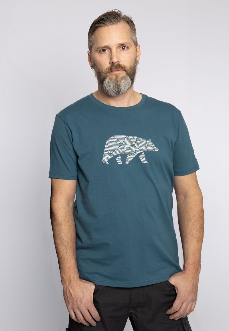 Teal katoenen t-shirt met een witte geometrische beerafbeelding op de voorkant, ronde hals en korte mouwen. Glad materiaal, casual pasvorm.
