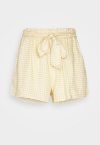Žluté a bílé kostičkované šortky s elastickým pasem a uvázaným látkovým páskem vpředu na bílém pozadí.