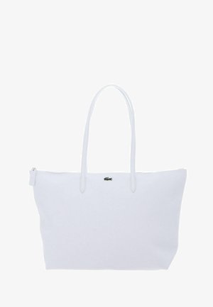 Sac cabas blanc avec deux longues poignées, fermeture éclair, et petit logo crocodile vert centré près du haut.