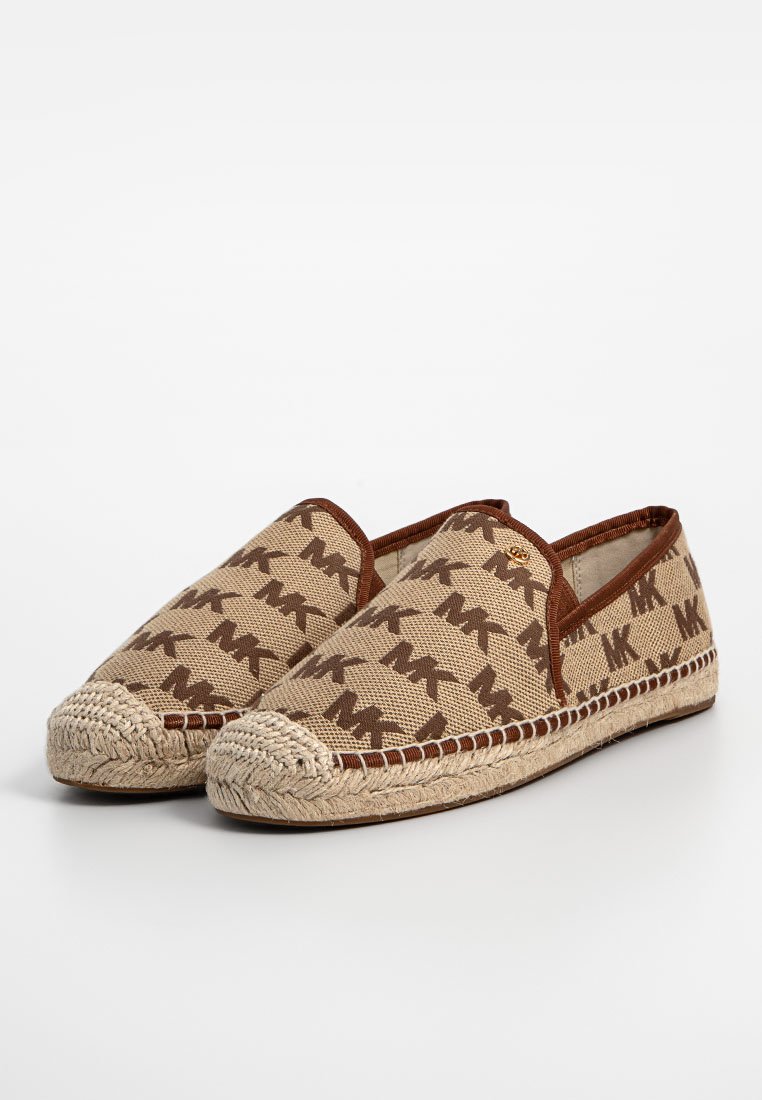Scarpe espadrillas realizzate in tela beige con un motivo a logo marrone. Presentano una suola in corda di juta e un bordo marrone attorno all'apertura.